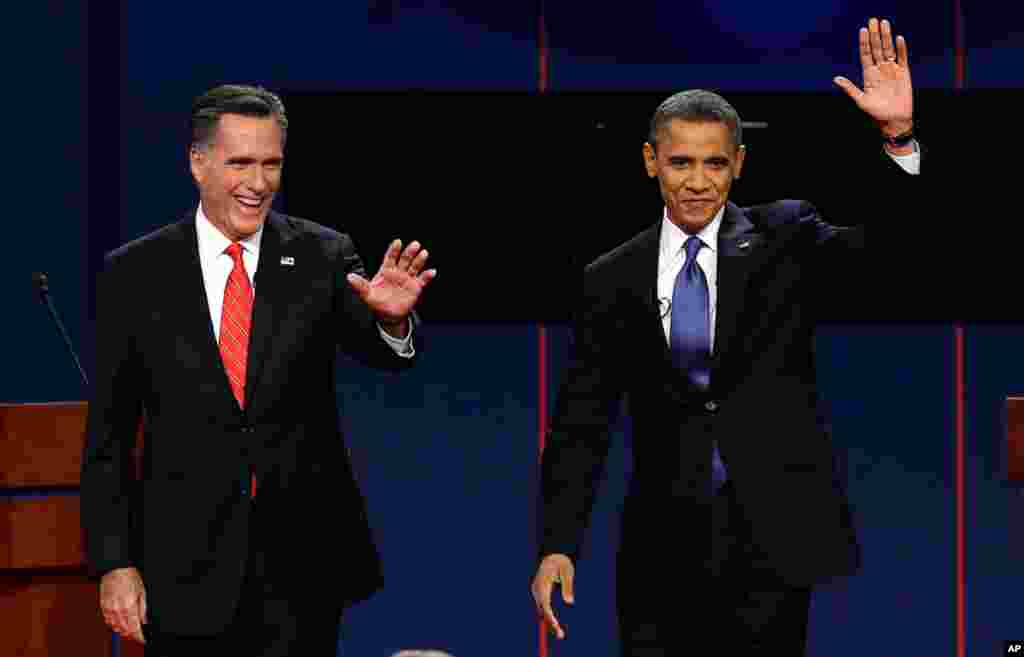 Mitt Romney and President Barack Obama wave to the crowd following the first presidential debate in Denver, Colorado, October 3, 2012