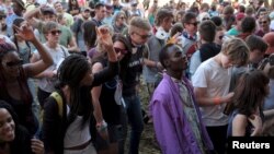 Revelers dance at the Oppikoppi music festival, in Limpopo, South Africa, Aug. 7, 2015. 