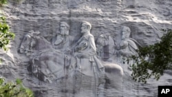 FILE - A carving in stone depicting Confederate Civil War figures Stonewall Jackson, Robert E. Lee and Jefferson Davis, in Stone Mountain, Georgia, June 23, 2015. The sculpture is America's largest Confederate memorial. 