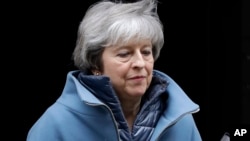 FILE - Britain's Prime Minister Theresa May leaves 10 Downing Street in London, Feb. 12, 2019. 