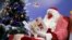 A postal worker dressed as Santa reads letters to addressed to 'Pere Noel' -- Father Christmas in French -- Nov. 23, 2020 in Libourne, France.