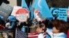 FILE - Uighur activists and their supporters rally in defense of Uighur rights in China, across the street from United Nations headquarters in New York City, March 15, 2018.