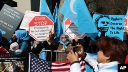 FILE - Uighur activists and their supporters rally in defense of Uighur rights in China, across the street from United Nations headquarters in New York City, March 15, 2018.