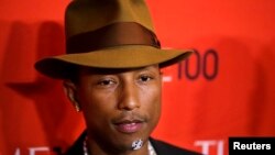 FILE - Pharrell Williams arrives at the Time 100 gala celebrating the magazine's naming of the 100 most influential people in the world for the past year, in New York, April 29, 2014. 