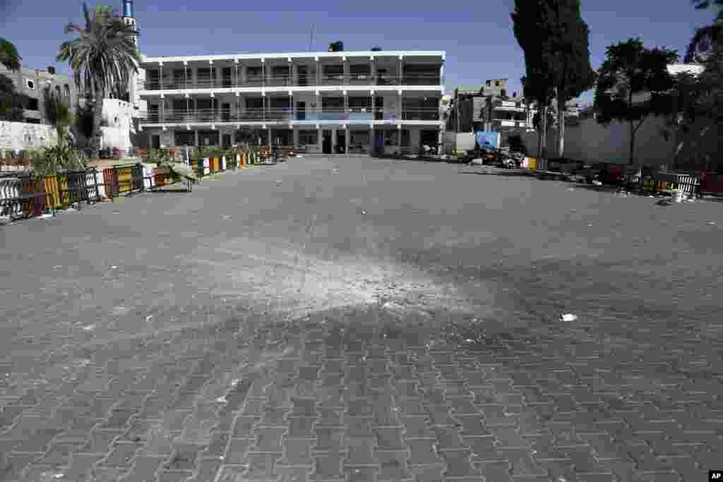 A crater from an Israeli strike is seen in the yard of the U.N. school in Beit Hanoun, in the northern Gaza Strip, July 24, 2014.