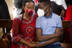 Ugandan musician turned politician Robert Kyagulanyi, right, also known as Bobi Wine, appears at the court with his wife Barbara Itungo, in Iganga, Nov. 19, 2020.