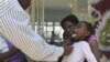 A doctor examins a child suffering from typhoid at a local infectious disease hospital in Harare, Tuesday, Nov.15, 2011. Health authorities say 207 cases of typhoid, spread by contaminated water and food, are being treated in Zimbabwe's capital after a pr