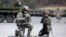 FILE - A U.S. Army soldier and a South Korean Army soldier take their position during joint military exercises between South Korea and the United States in Pocheon, north of Seoul, South Korea, March 25, 2015.