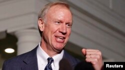 FILE - Illinois Gov-elect Bruce Rauner talks to the media after a meeting with U.S. President Barack Obama at the White House in Washington, Dec. 5, 2014.