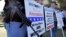 FILE - Gun rights supporters stand outside the Capitol in Phoenix during a Guns Across America rally. 