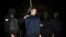 FILE - Iranian policemen prepare to hang a young convict in Tehran, Iran, Jan. 20, 2013. 