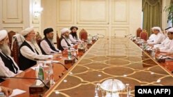 Mutlaq bin Majid al-Qahtani (R), special envoy of of the Qatari Foreign Minister for counterterrorism and mediation in conflict resolution, meets with members of Taliban's peace negotiation team in Doha, June 9, 2021.