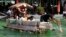 Filipinos paddle on a small boat they made with used plastic bottles and other recycled materials to join a boat-making competition in Manila, Philippines.