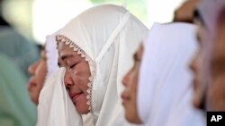 A woman weeps during a prayer marking 20 years of the massive Indian Ocean tsunami, in Banda Aceh, Indonesia, Dec. 26, 2024.