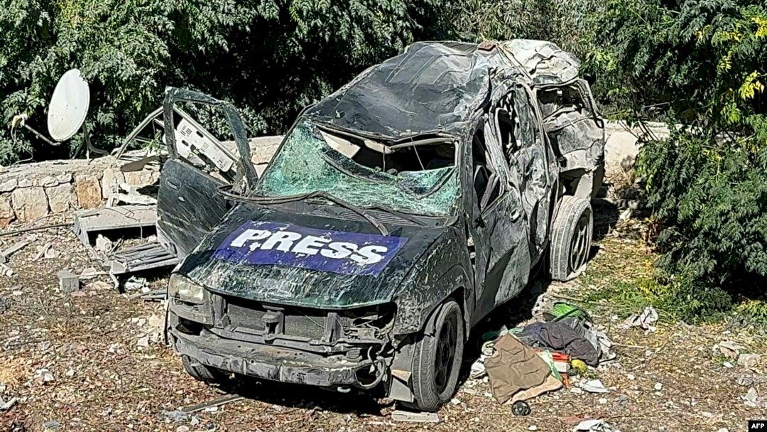 A destroyed car marked "Press" is seen at the site of an Israeli airstrike that targeted an area where a number of journalists were located in the southern Lebanese village of Hasbaya on Oct. 25, 2024.