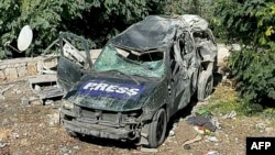 A destroyed car marked "Press" is seen at the site of an Israeli airstrike that targeted an area where a number of journalists were located in the southern Lebanese village of Hasbaya on Oct. 25, 2024.