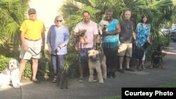 These pet owners and their charges, fleeing from Hurricane Florence, wound up at a Jacksonville, Florida, hotel. (N. Belfiore-Dulay)