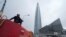 FILE - A worker sits on his water tank truck next to the business tower Lakhta Centre, the headquarters of Russian gas monopoly Gazprom in St. Petersburg, Russia, April 27, 2022. 