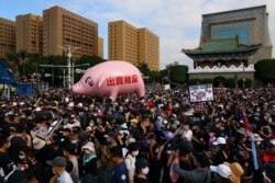 FILE - People join a protest to oppose the import of U.S. pork containing ractopamine, an additive that enhances leanness in Taipei, Taiwan, Nov. 22, 2020.