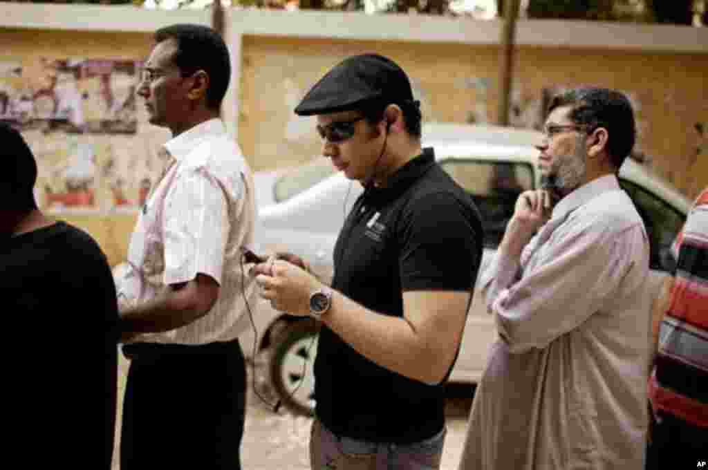 Ahmed Maher, a co-founder of the April 6 Revolutionary Movement, waits in line to vote at a polling center in Maadi, a southern suburb of Cario, Egypt on Wednesday, May 23, 2012. The April 6 Movement was one of the leading youth protest movements during t