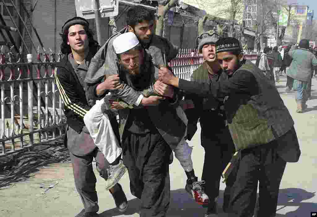 Afghans carry a wounded man during an anti-U.S. demonstration in Kunduz, north of Kabul, on February 25, 2012. (AP)