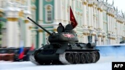 FILE - A Soviet WWII-era T-34 tank rolls on Dvortsovaya Square during the general rehearsal of Jan. 27 military parade marking the 75th anniversary of the lifting of the Nazi siege of Leningrad, in Saint Petersburg, Jan 24, 2019.