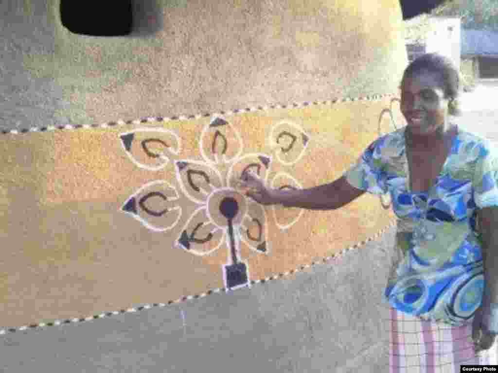 A woman decorating her hamlet in Matobo district, Matabeleland South Province