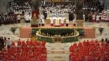 In this photo provided by the Vatican newspaper <em>L&#39;Osservatore Romano</em>, Pope Francis, top center, leads a consistory inside the St. Peter&#39;s Basilica at the Vatican. Retired Pope Benedict XVI joined Pope Francis at a ceremony creating the cardinals who will elect their successor in an unprecedented blending of papacies past, present and future.