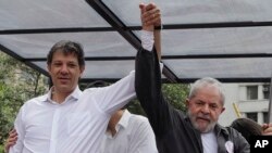 FILE - Brazil's former President Luiz Inacio Lula da Silva, right, campaigns with Sao Paulo's Mayor Fernando Haddad in Sao Paulo, Brazil, Sept. 30, 2016.