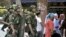 Armed police officers stand guard near international grand bazaar in Urumqi, Xinjiang Uighur Autonomous Region, June 29, 2013.