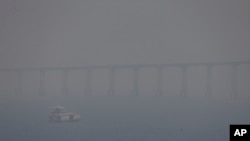 FILE - A vessel  navigates the Negro River amid fume  from wildfires successful  Manaus, Amazonas state, Brazil, Aug. 27, 2024.