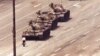 FILE - A man stands in front of a convoy of tanks in the Avenue of Eternal Peace in Beijing, China, June 5, 1989. 