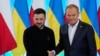 Polish Prime Minister Donald Tusk, right, welcomes Ukrainian President Volodymyr Zelenskyy after the two countries reached an agreement on exhuming Polish victims of WWII-era massacres by Ukrainian nationalists, in Warsaw, Poland, Jan. 15, 2025.