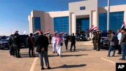 FILE - Iraqi and Saudi officials open the Arar border crossing, in Anbar, Iraq, Nov. 18, 2020. 