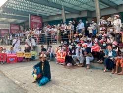 A protester flashes the three-fingered salute during an anti-coup protest outside the Hledan Centre in Yangon, Myanmar, Feb. 21, 2021.