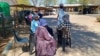 FILE - Women queue to vote at a polling station in Kumakwane, Botswana, on Oct. 30, 2024. Authorities said on Jan. 14, 2025, that over a two-week period in December and January, 93 cases of rape and 10 murders of women were reported in Botswana.