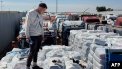 Trucks carrying humanitarian aid line up on the Egyptian side of the Rafah border crossing with the Gaza Strip, March 2, 2025, after Israel suspended the entry of supplies into the Palestinian enclave. 