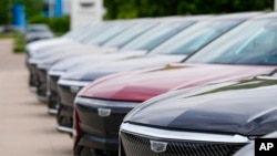 FILE - Unsold 2024 electric Lyriq utility vehicles sit outside a Cadillac dealership on June 2, 2024, in Lone Tree, Colo.