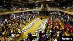 South Africa's parliament approves a report endorsing a constitutional amendment that will allow expropriations without compensation.