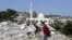 Boys walk amongst the rubble of the house of Palestinian assailant Ahmed Najeh Abu al-Rub after it was demolished by Israeli forces in the West Bank town of Qabatya near Jenin, April 4, 2016.