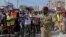 FILE - A Somali soldier controls the crowd as thousands of people attend a protest rally in Mogadishu, Somalia, January 3, 2024, after an agreement signed between Ethiopia and the breakaway region of Somaliland to give landlocked Ethiopia access to its shoreline. 