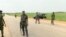 FILE - A still image taken from a video shot on June 25, 2018, shows security officers on the street in Plateau, Nigeria. 