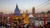 Devotees gather for an evening prayer on the banks of Ganges river during Kumbh Mela, or the Pitcher Festival, amidst the spread of the coronavirus disease (COVID-19), in Haridwar, India, April 10, 2021. REUTERS/Danish Siddiqui