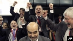 Newly elected Food and Agriculture Organization Director-General, Jose Graziano da Silva of Brazil, center, is cheered by delegates after being elected at FAO's Headquarters in Rome, Sunday, June 26, 2011.