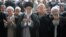 FILE - A handout picture released by the official website of the Iranian supreme leader, Ayatollah Ali Khamenei, shows him, center, leading Eid al-Fitr prayers, with Iranian President Hassan Rouhani at far right, at Tehran's Grand Mosalla, July 18, 2015.