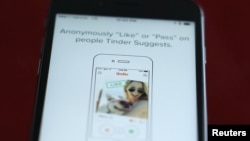 FILE - The dating app Tinder is shown on an iPhone in an illustration photo taken Feb. 10, 2016.