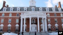FILE - In this Feb. 5, 2019, file photo, students walk on the campus of Green Mountain College in Poultney, Vermont. The college, which opened in 1834, closed in 2019.