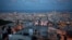 People gather outdoors at dusk on a viewpoint in Barcelona, Spain, Saturday, July 25, 2020. Britain is advising people not to travel to Spain and has removed the country from the list of safe places to visit following a surge of COVID-19 cases. (AP…