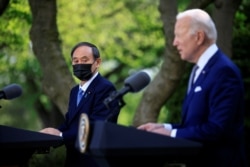 Japan's Prime Minister Yoshihide Suga and U.S. President Joe Biden hold a joint news conference in the Rose Garden at the White House in Washington, April 16, 2021.