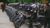 FILE PHOTO - Cambodian military police officers stand by with their motorcycles at Stung Meanchey where Prime Minister Hun Sen made his first public appearance since Sunday's election, in Phnom Penh, Cambodia, Wednesday, July 31, 2013. (AP Photo/Heng Sinith)